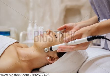 Lateral View Of Woman Facial Massage Spa Procedure. Electric Stimulation Facial Skin Care. Microcurr