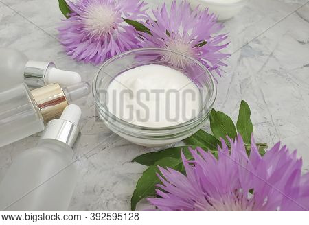 Cream Cosmetic Flower On Concrete Background  Essence