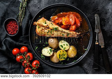 Cooking In Tomatoes Monkfish Fish With Baked Potatoes. Fresh Seafood. Black Background. Top View