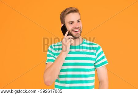 Importance Of Being Communicative. Happy Man Talk On Mobile Phone Yellow Background. Verbal Communic