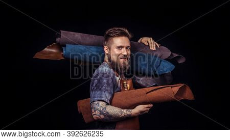 Worker Of Leather Cuts Out Leather Goods In A Workshop