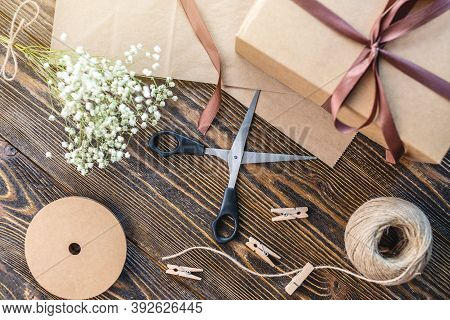 Craft Paper And Tools For Creating And Decorating Gift Packaging. There Is Cardboard, Brown Ribbons 
