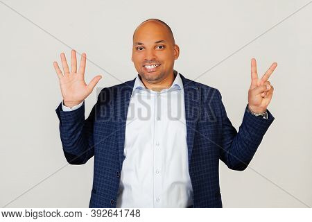 Portrait Of Successful Young African American Businessman Guy, Showing With Fingers To Number Seven,