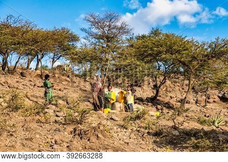 Lalibela, Ethiopia - Feb 12, 2020: People Getting Water At A Water Point In Lalibela, Ethiopia. Afri