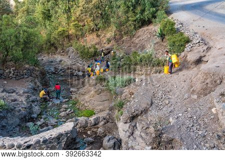 Lalibela, Ethiopia - Feb 12, 2020: People Getting Water At A Water Point In Lalibela, Ethiopia. Afri