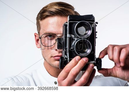 Young Photographer In Glasses Capture Image Looking In Eye Of Retro Camera Isolated On White, Shoot