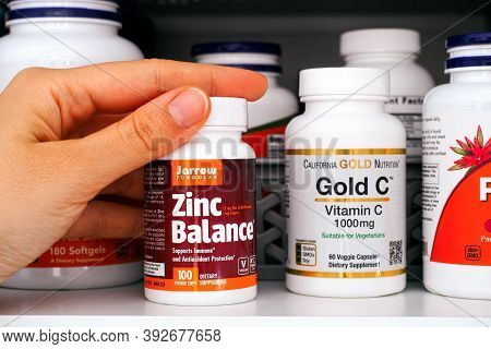 Tambov, Russian Federation - Ocrober 28, 2020 Person Taking Out A Bottle Of Zinc Balance Pills By Ja
