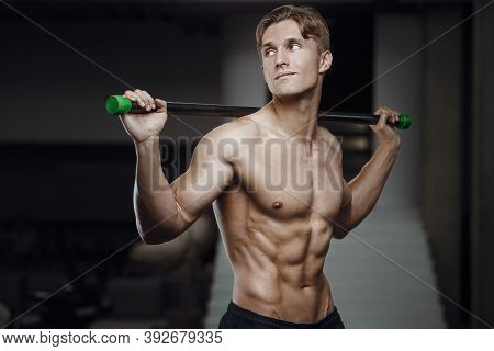 Fitness Man At Workout In Gym With Bodybar Stretching Muscles. Workout Fitness And Bodybuilding Heal