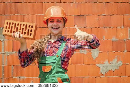 Little Worker In Helmet Building From Brick. Architecture Construction Child. Child In Uniform Worki