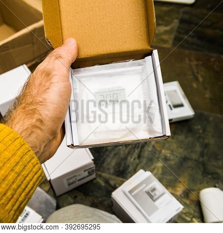 Paris, France - Oct 25, 2020: Man Hand Holding Unboxing New Vaillant Ambisense Vr51 Room Thermostat 