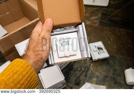 Paris, France - Oct 25, 2020: Man Hand Holding Unboxing New Modern With Display Vaillant Ambisense V