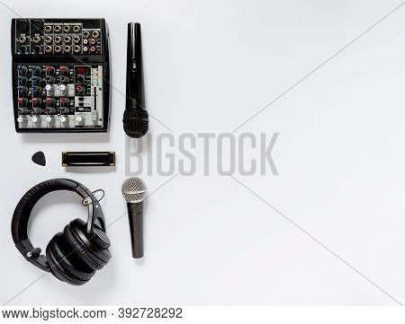 Black And White Flat Lay Composition With Microphones, Headphones, Mixing Console, Harmonica And Pic