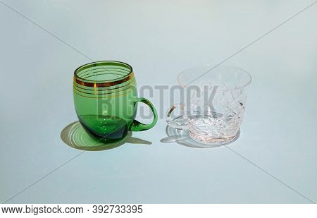 Two Empty Crystal Cups Stand Next To Each Other Side View