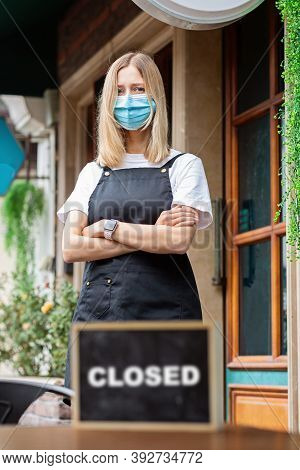 Caucasian Waitress Woman Wearing Medical Mask Holds Sorry Were Closed. Coronavirus Pandemic. Governm