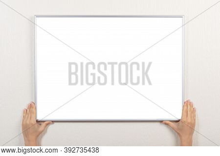Woman Hands Hold Silver Blank Frame. Mockup Frames For Picture Of Certificate, Diploma Or Photo. Wom