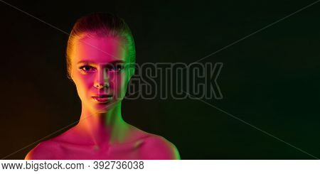 Mavelous. Portrait Of Fashion Model In Neon Light On Dark Studio Background. Beautiful Caucasian Wom