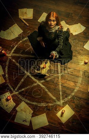 A portrait of a scary witch in the wooden house in green smoke. Magic, dark force, spell. 