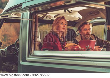 Caucasian Couple Watching Exciting Tv Game Inside Self Made Camper Van Rv During Scenic Autumn Weeke