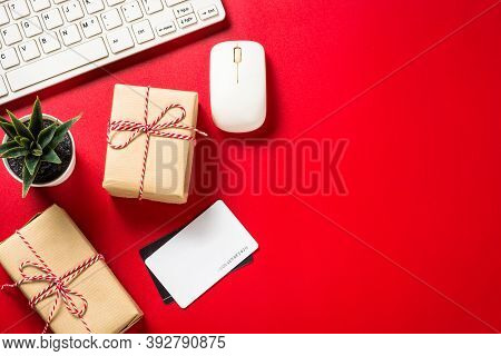 Omline Shopping Concept With Present Boxes, Laptop And Credit Cards At Red Background. Top View With