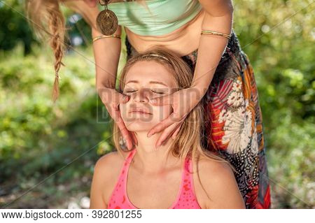 Massage Girl Thuroughly Massages A Girl On The Forest Floor.
