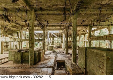View Of Abandoned Empty Buildings Of Old Tin Mine. Industrial Dirty Building Interior. Damaged Facto