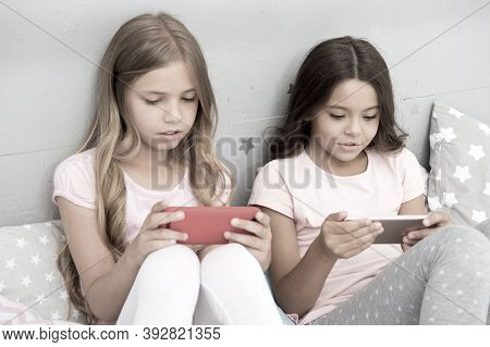 Children In Pajama Interact With Smartphones. Application For Kids Fun. Internet Surfing And Absence