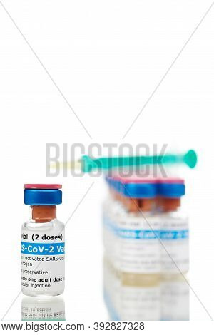 Bottles Of New Sars-cov-2 Vaccine On Table With Plastic Syringe