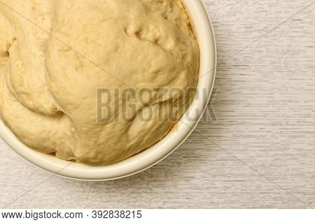 Live Yellow Dough In A Bowl. The Final Fermentation Process.