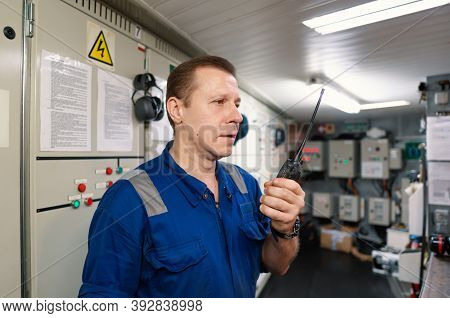 Marine Engineer Working On Radio Communication At Engine Control Room Ecr