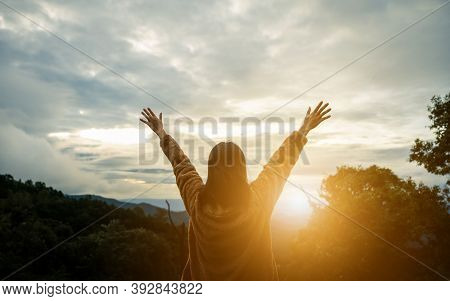Freedom Concept. Happy Woman On The Sunset In Nature In Winter With Arm Raised And Open Hand