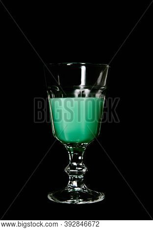 Goblet Of Absinthe On A Black Background. Glass With Absinth