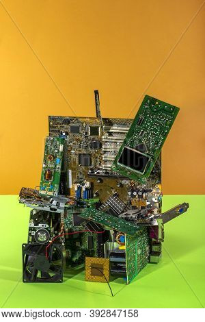 Abstract Figure Folded From Computer Circuit Boards On A Colored Background