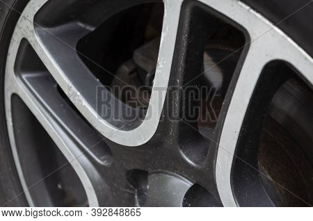 Wheel Rim With Scratches And Dirt. Scratches And Abrasions On The Cast Wheel Rim. Auto Parts Concept