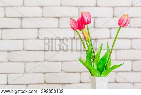 Tulip Flower On White Vase On White Birck Wall Background Copy Space.