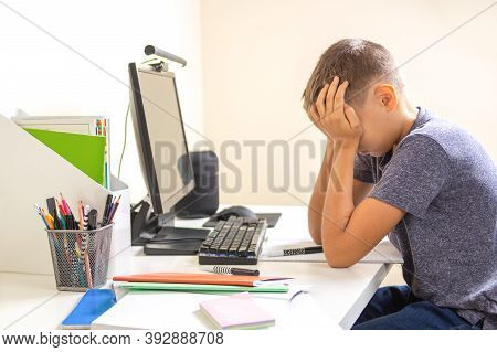 Kid With Computer Doing Homework At Home. Learning Difficulties, Online Learning, Education Concept
