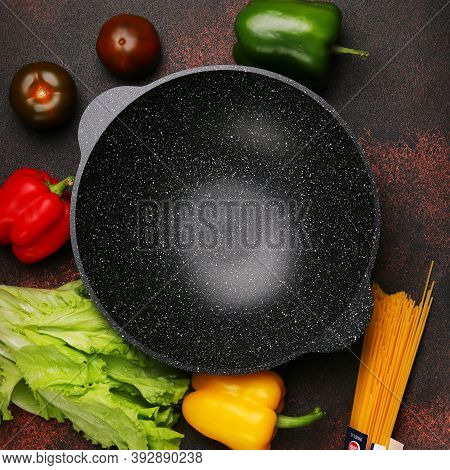 Empty Wok Pan With Ingredients, Fresh Vegetables And On Metal Culinary Background