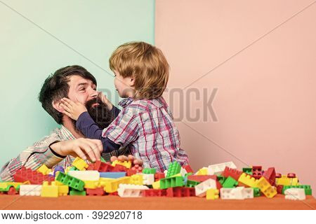 Surefire Ways To Bond With Your Son. Father Son Game. Dad And Kid Build Plastic Blocks. Child Care D