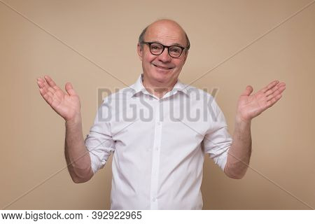 Man In Glasses Having Confused Look, Shrugging Shoulders