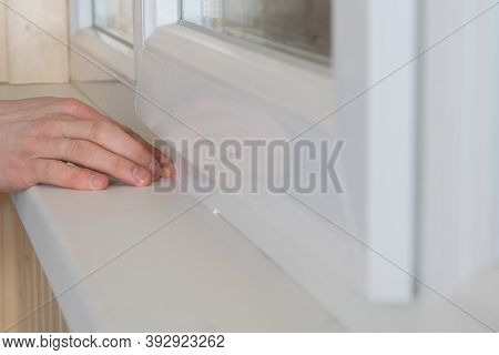 Close-up Of A Worker's Hand Smearing The Cracks With Silicone For Insulation