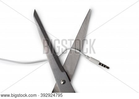 Conceptual Photo Of Cut Off The Earphones Wire. Bluetooth Headphones Are A New Trend. Wireless Techn