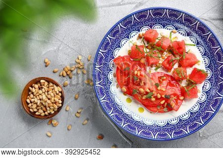 Stracciatella Salad With Tomatoes And Watermalone And Ingredients On Light Concrete Table Top View