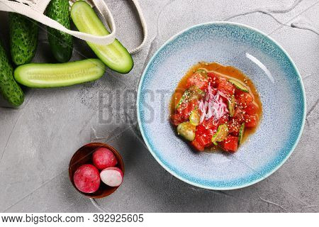 Tuna Ceviche On Light Concrete Table Top View. Fresh Tuna Tartar With Vegetables