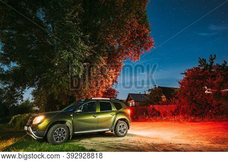 Dobrush, Belarus - August 4, 2020: Renault Duster Suv Dirty Car Parking On Street Under Night Starry