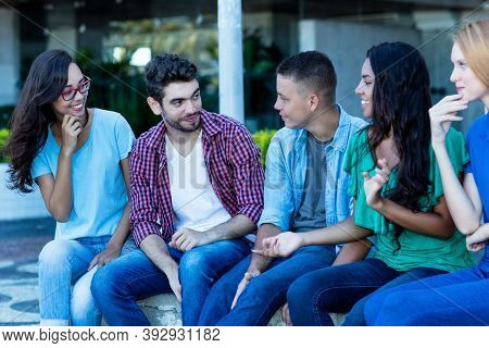 Group Of Multi Ethnic Young Adults In Poltical Discussion Outdoor In City