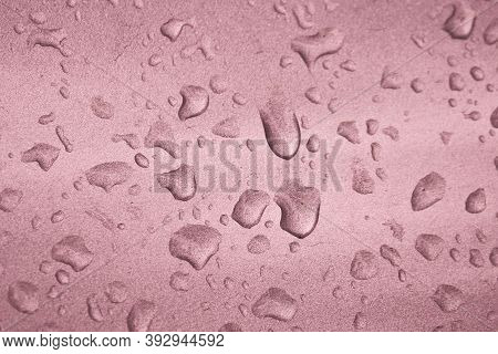 Raindrops On The Silvery Coral Pink Surface Of The Car. Selective Focus.