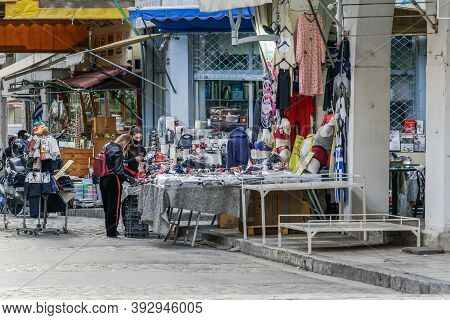 Thessaloniki, Greece - November 02 2020: People At Outdoor Shop With Covid-19 Masks. Unidentified Fe