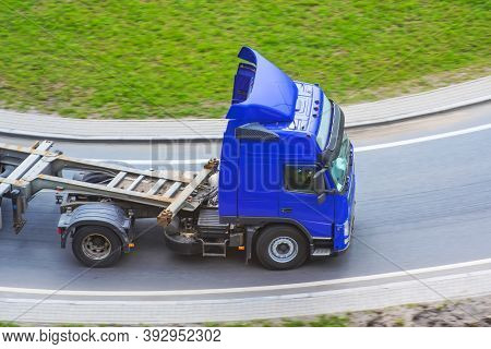 Truck With Platform Trailer On The Bend