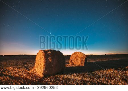 Comet Neowise C2020 F3 In Night Starry Sky Above Haystacks In Summer Agricultural Field. Night Stars