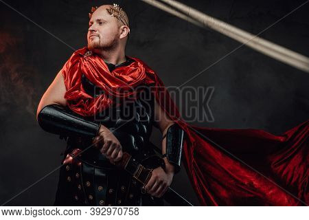 Handsome And Hairless Roman Guardian With Red Cloak And Black Armour Poses With Sheathed Sword In Da