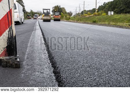 A Large Layer Of Fresh Hot Asphalt. Layer Of Asphalt Raw Material In A Shallow Depth Of Field. Rolle